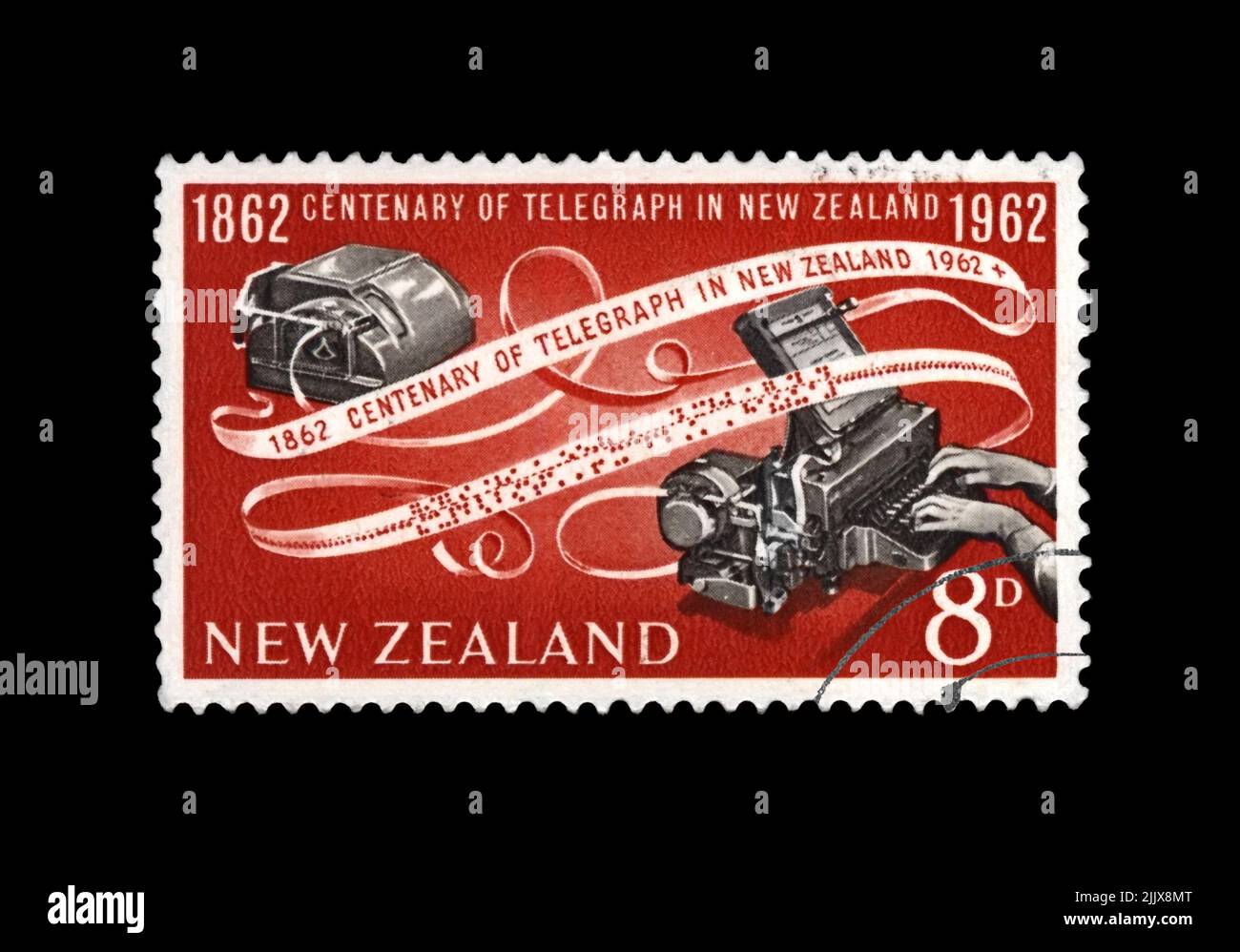 telegraph device and encoded paper tape, 100th anniversary of inauguration of the telegraph in New Zeland, circa 1962. canceled postal stamp . Stock Photo
