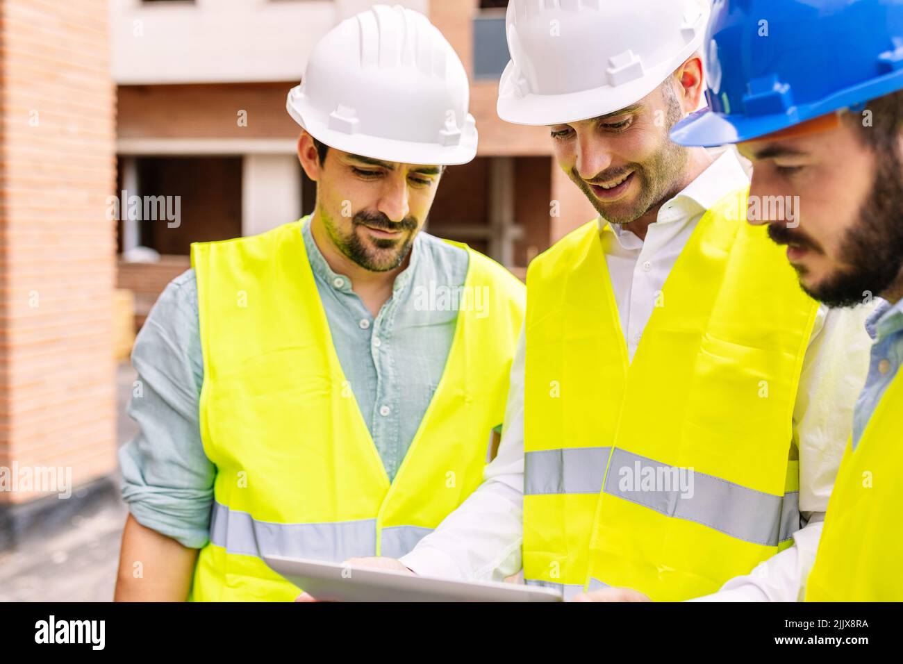 Construction architect engineers working on building site Stock Photo