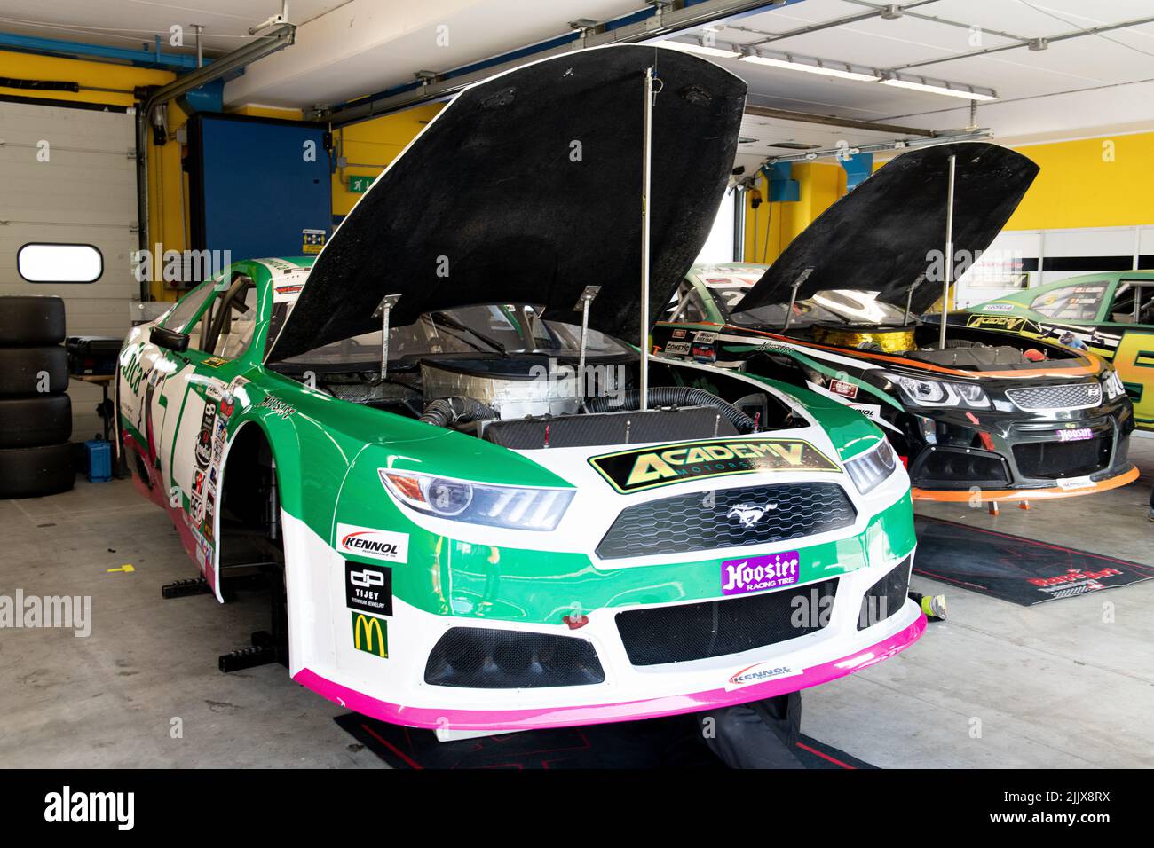 Nascar cars with open hood aligned in workshop. Vallelunga, Italy, october 29 2021. American festival of Rome Stock Photo