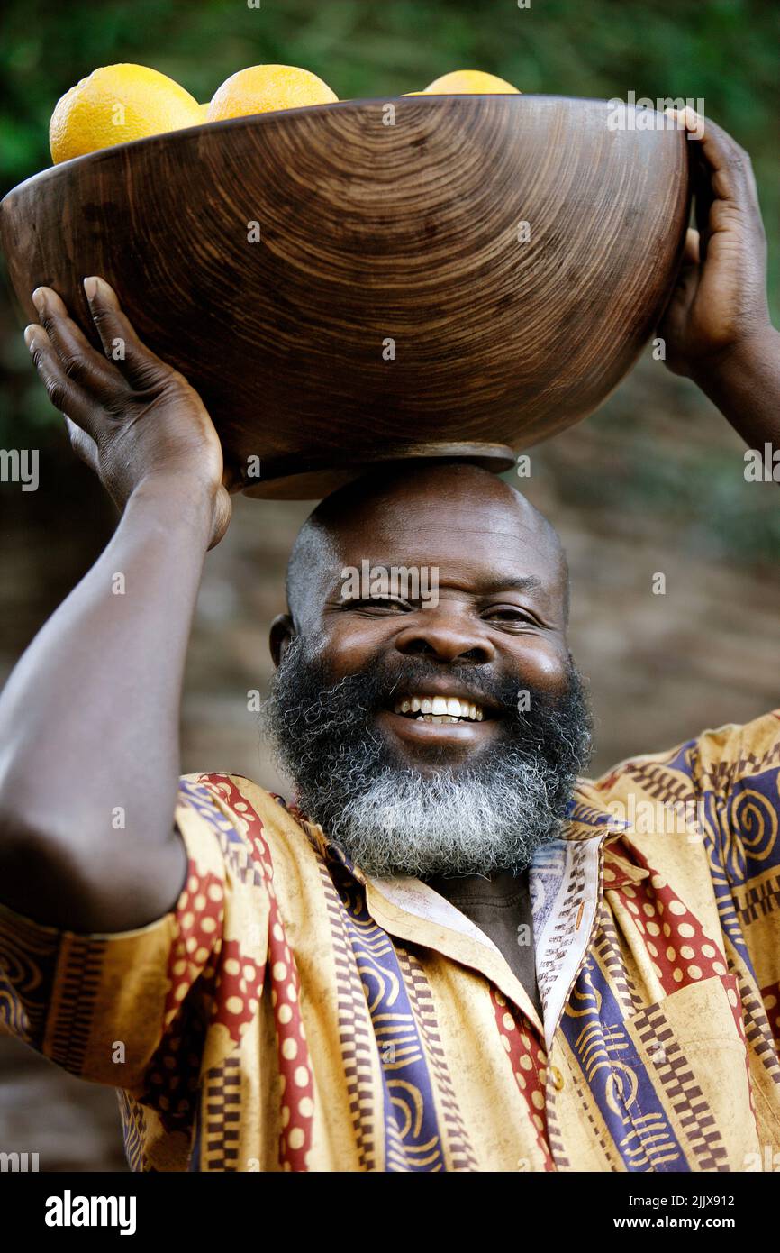 Smiling African man with fruit bowl Stock Photo