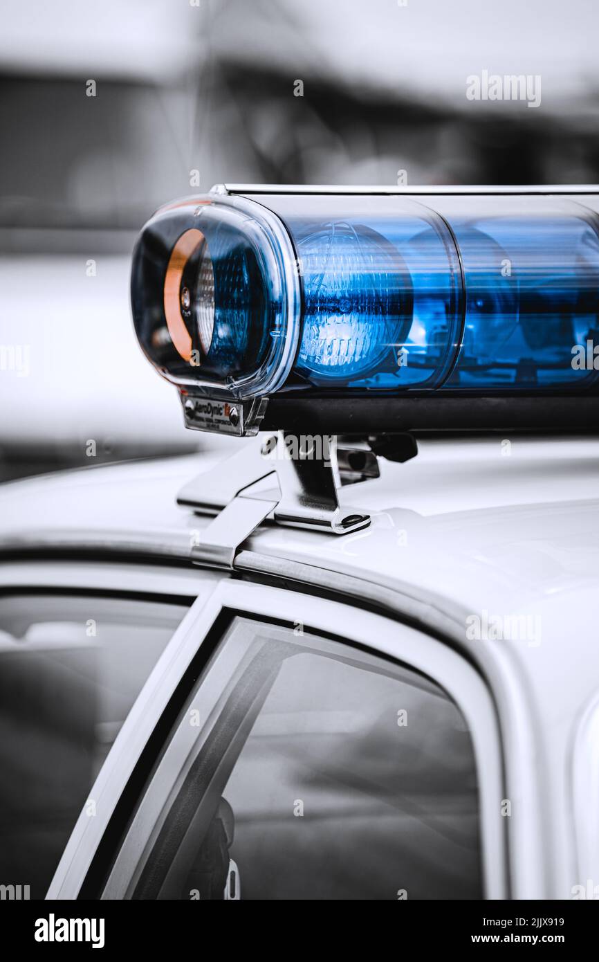 A blue light on top of a police car Stock Photo Alamy