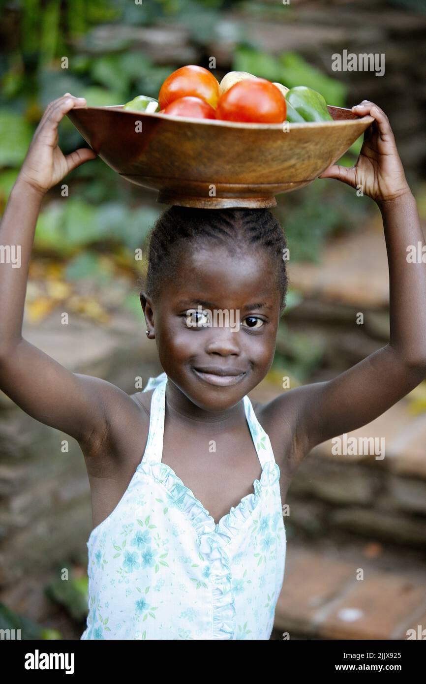 African Girl with fruit bowl Stock Photo