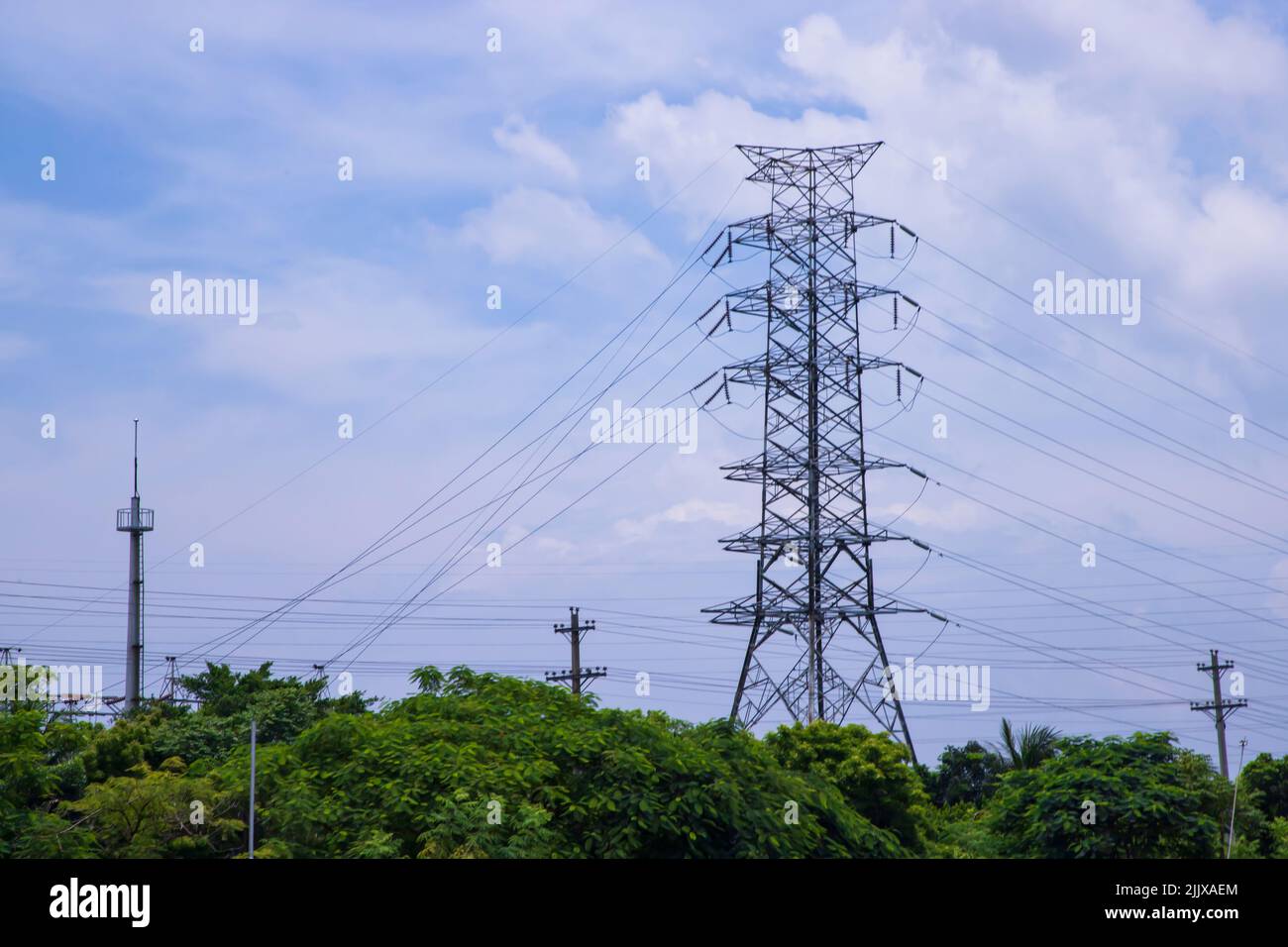 High voltage Electricity pylon under the cloudy blue sky Stock Photo ...