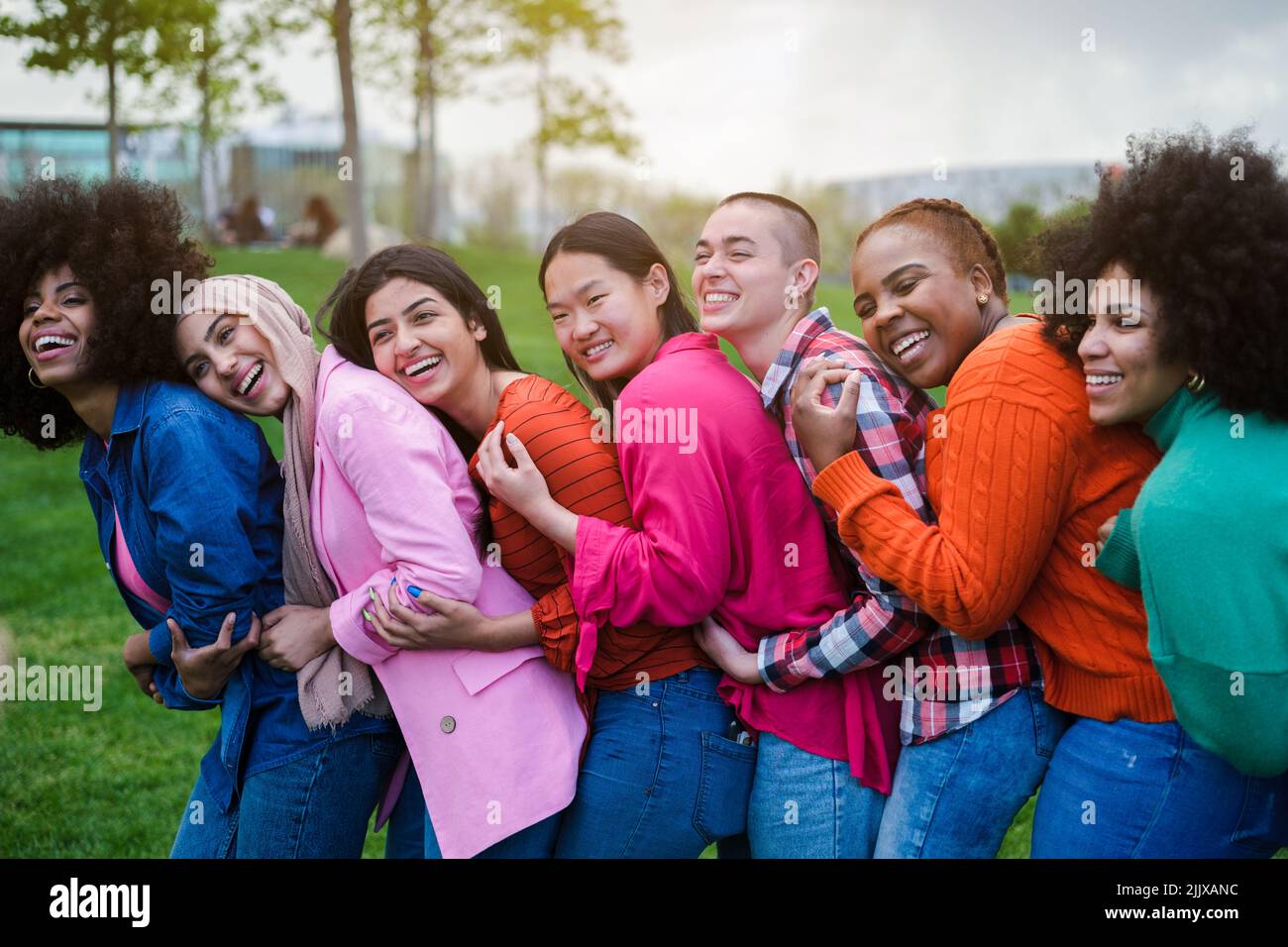 Group of young women of different ethnicities gathered having a good ...