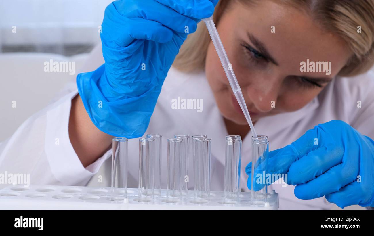professional scientist laboratory assistant takes and examines samples