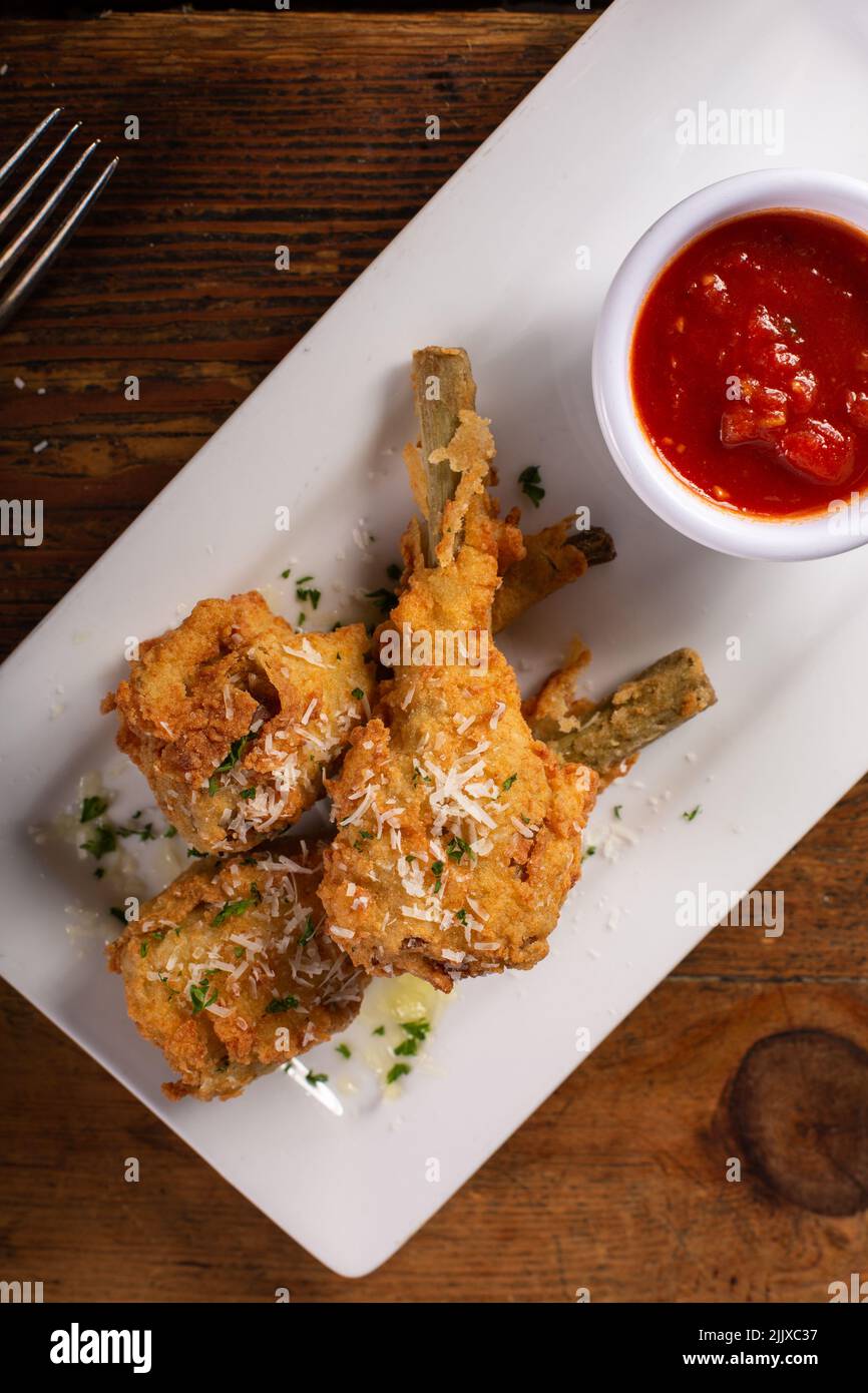 Italian fried lamb chops served with marinara sauce Stock Photo Alamy