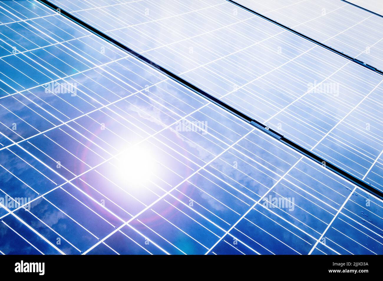 Close up of solar panels with reflecting sun and lens flaring Stock Photo
