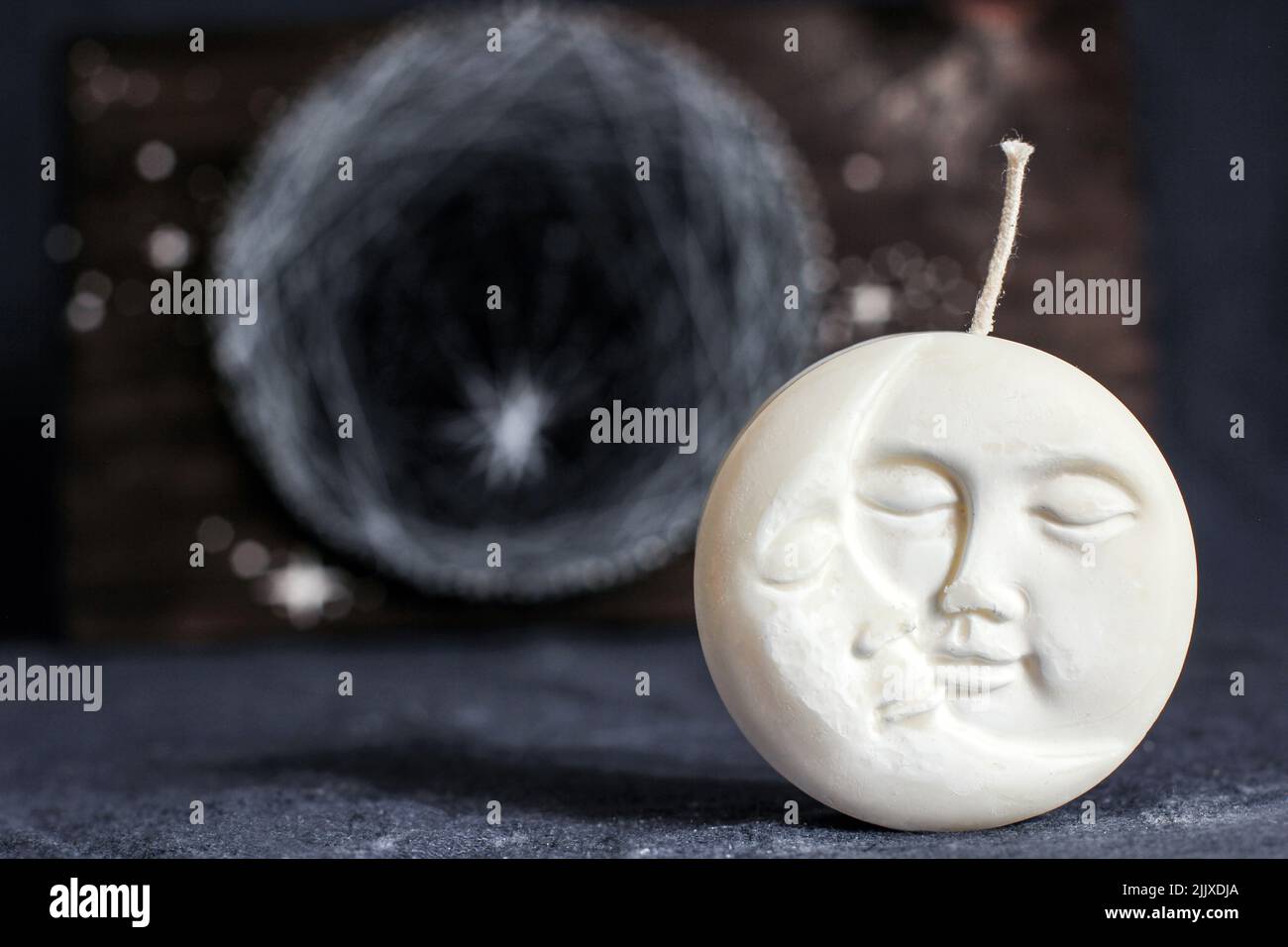 Candle in the shape of the moon. Lunar decor Stock Photo - Alamy