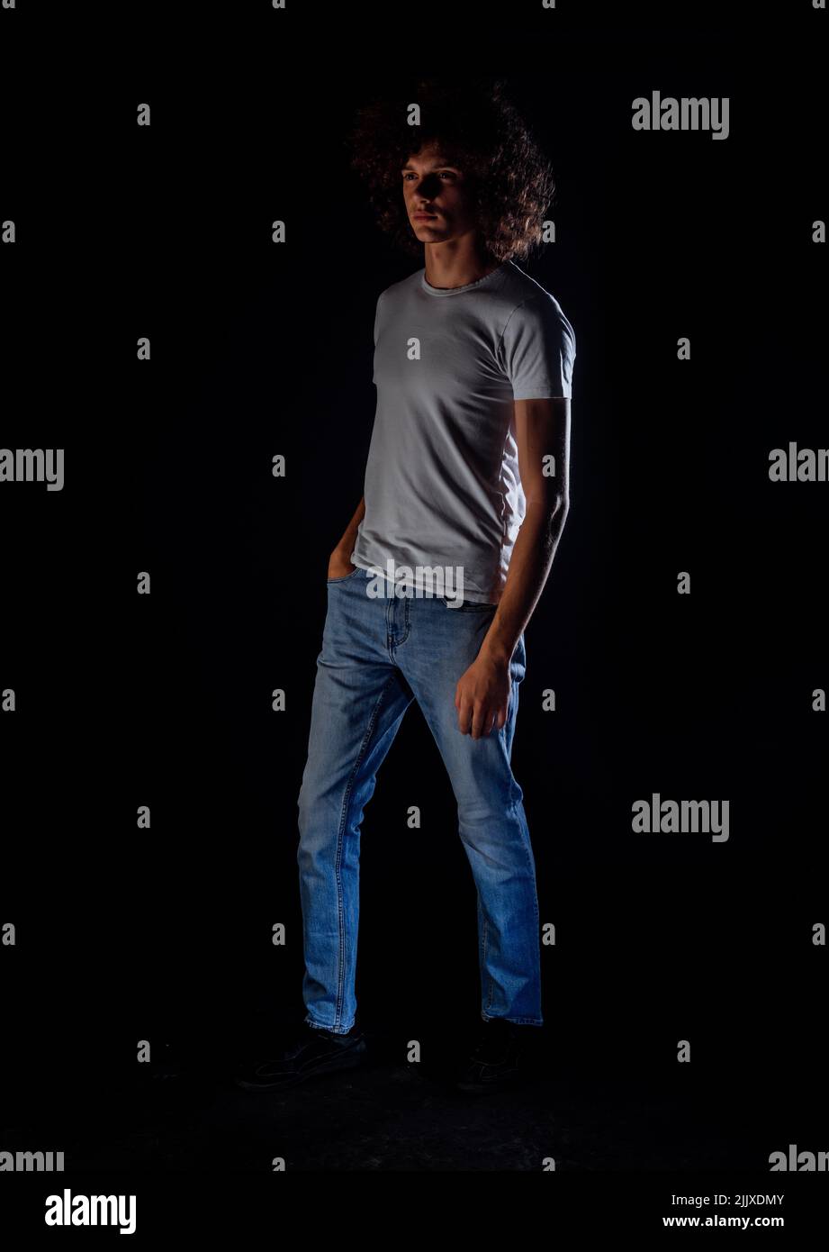 Studio body shot of a fashion male model wearing stylish clothes while ...