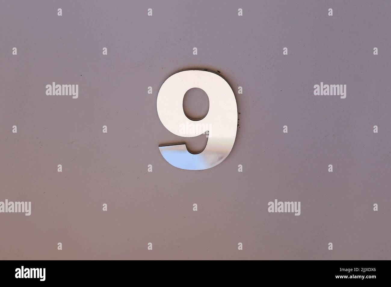 number nine in metallic plate format, with copy space and gray tone - 9 Stock Photo
