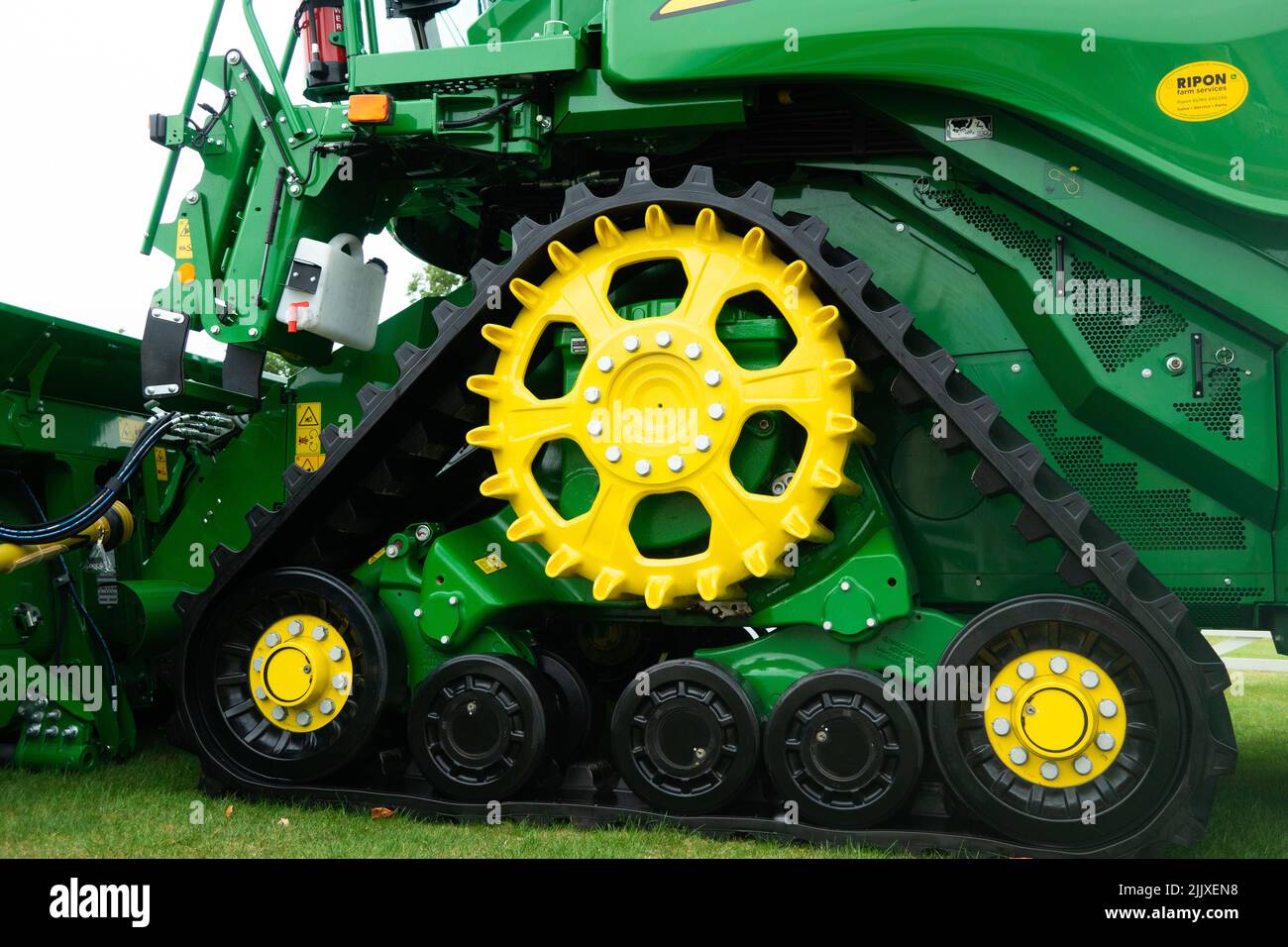 Giant wheels and track system on a JRX John Deere Tractor whiche protect soil helps to prevent slipping. Tracks have much greater ground contact area Stock Photo
