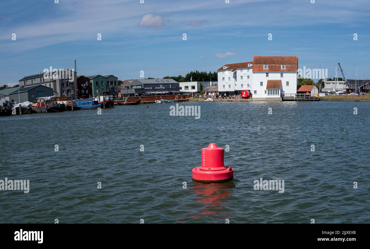 Red Channel mark in the river Deben estuary at Woodbridge Suffolk with White tide mill in the background Stock Photo