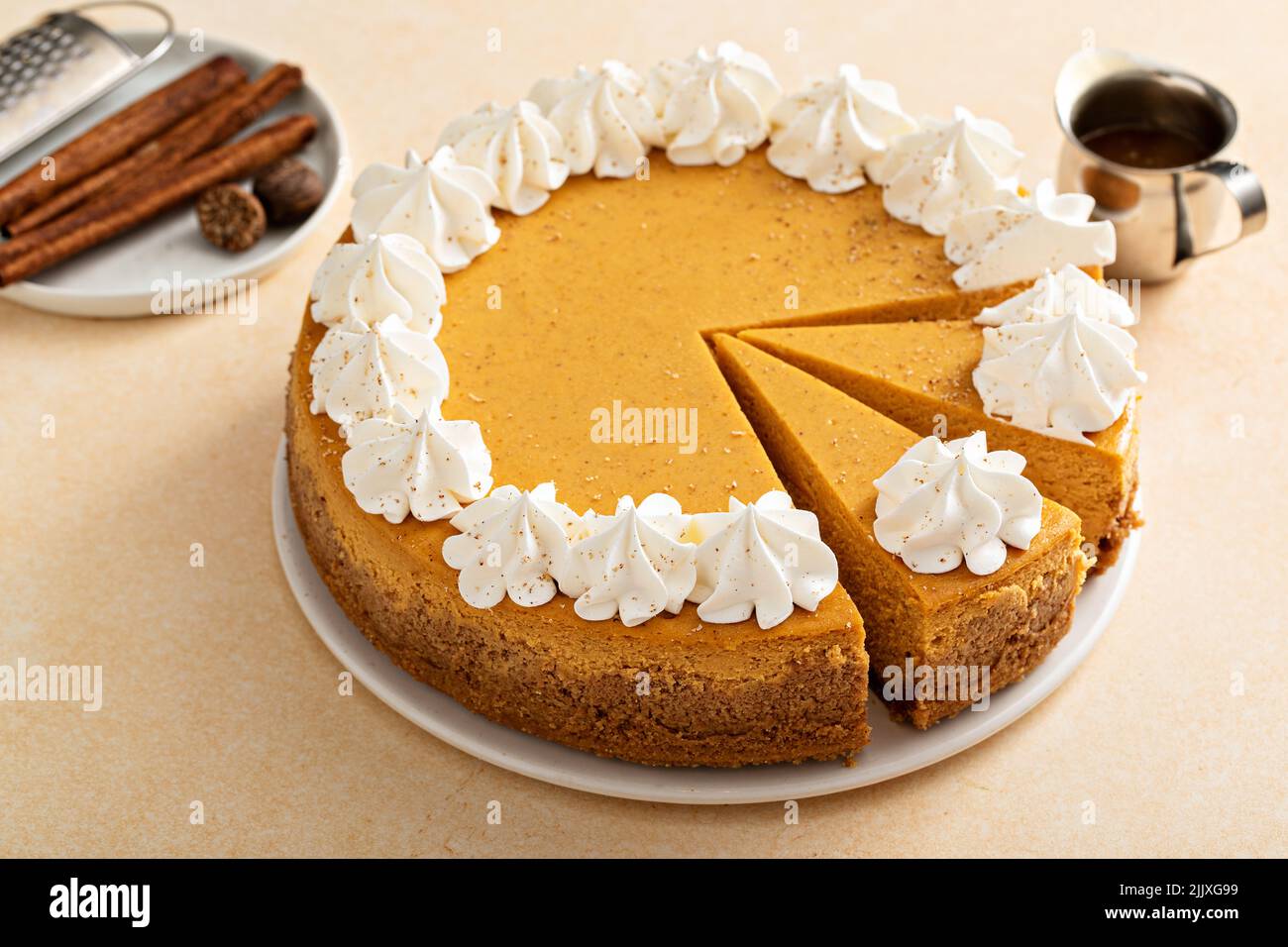 Pumpkin cheesecake with fall spices topped with whipped cream Stock