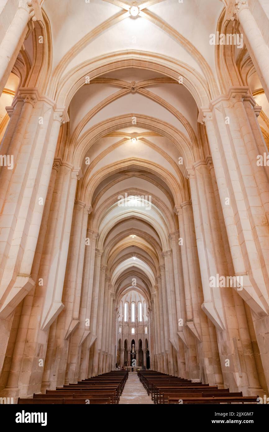 The tall and impressive nave of the church in the Monastery and World Heritage Site Mosteiro de Alcobaca, Portugal Stock Photo
