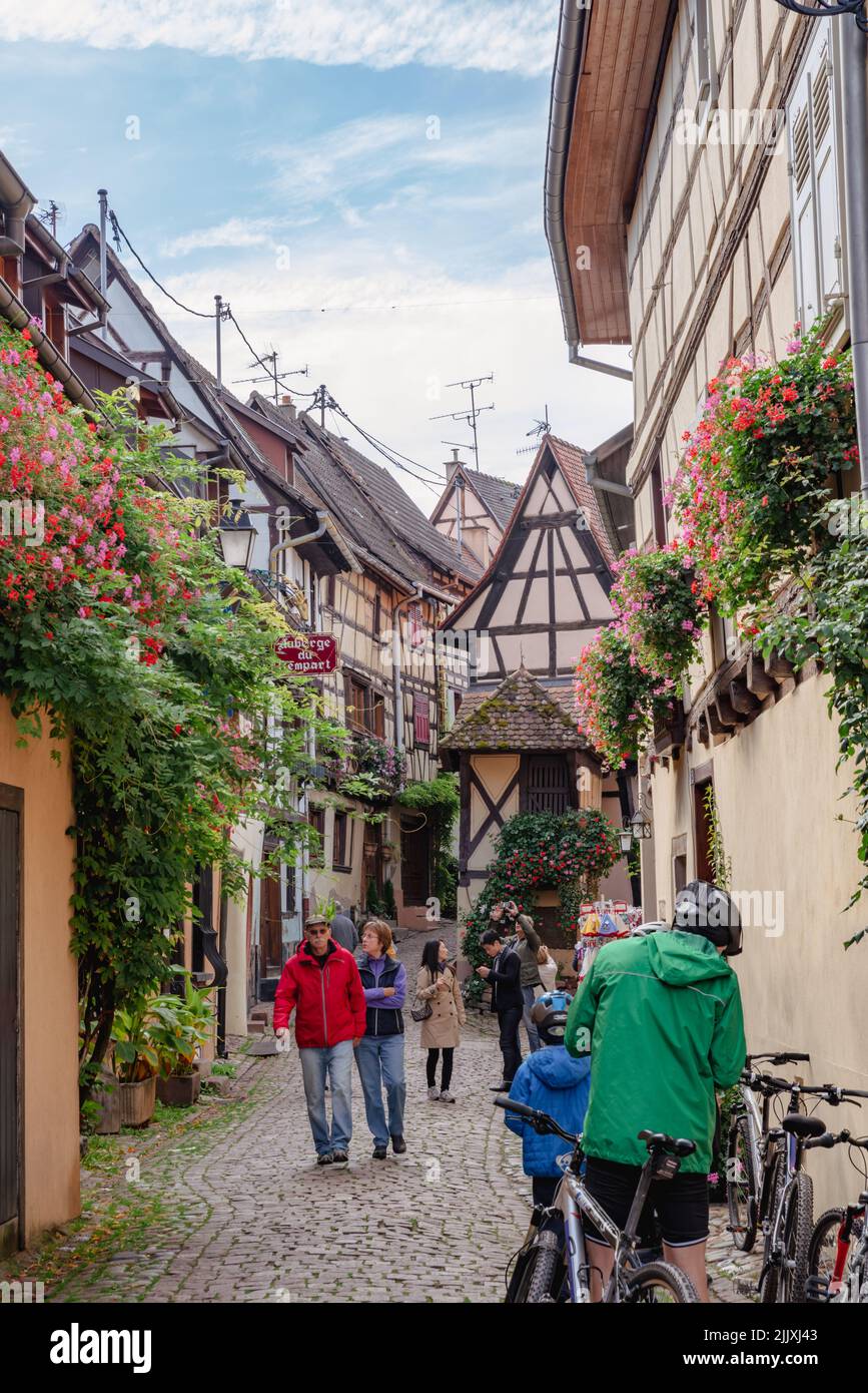 Tourists are sightseeing in French Alsace historic town.  Stock Photo
