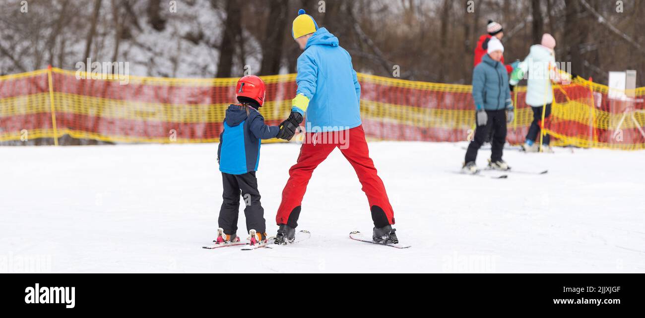 skiing master class for kids with instructor in winter sports school for children Stock Photo