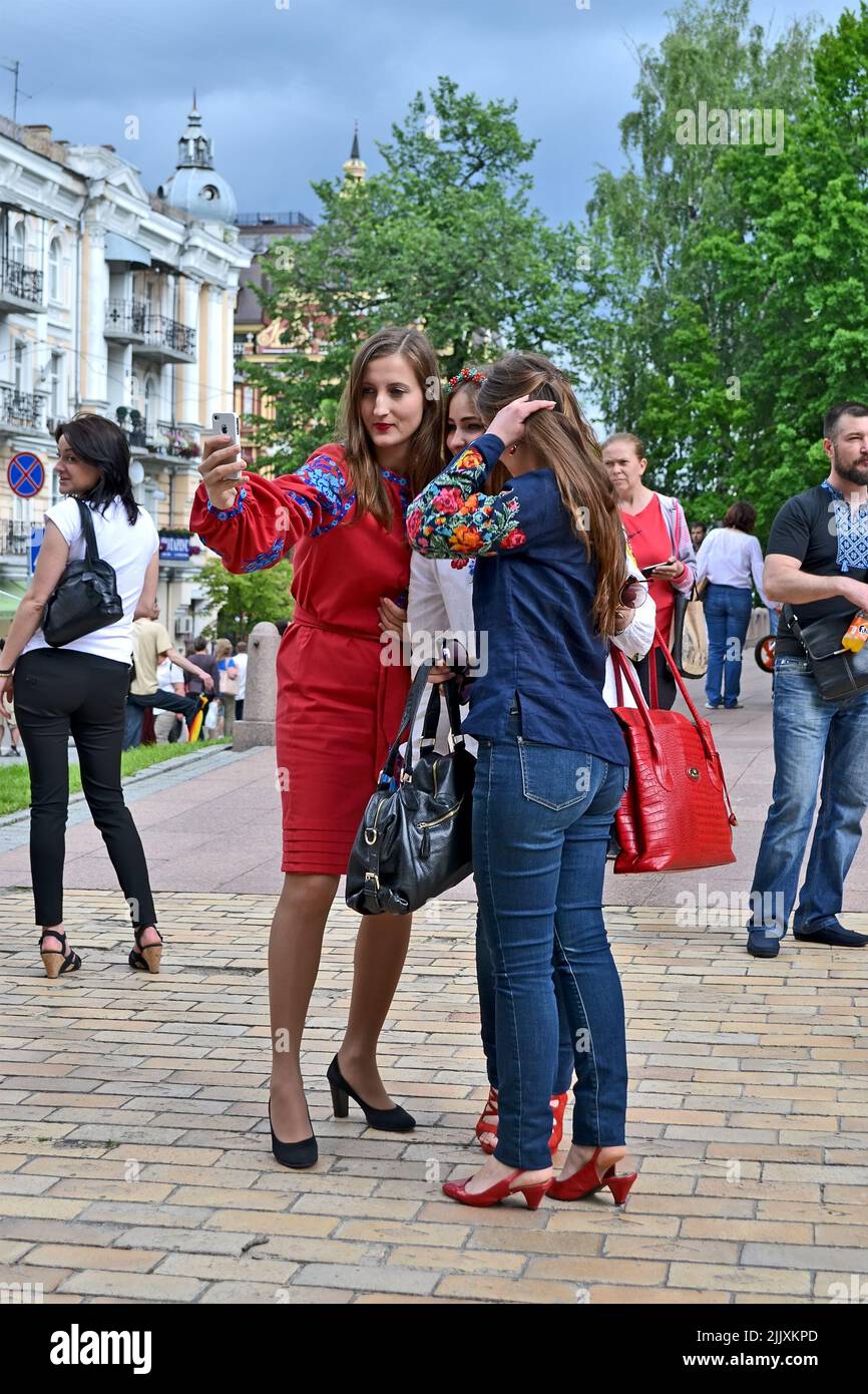 cameraman woman. Unknown young females in national costumes make the selfie during Embroidery dress (Vyshyvanka) parade in Kiev, Ukraine. Stock Photo