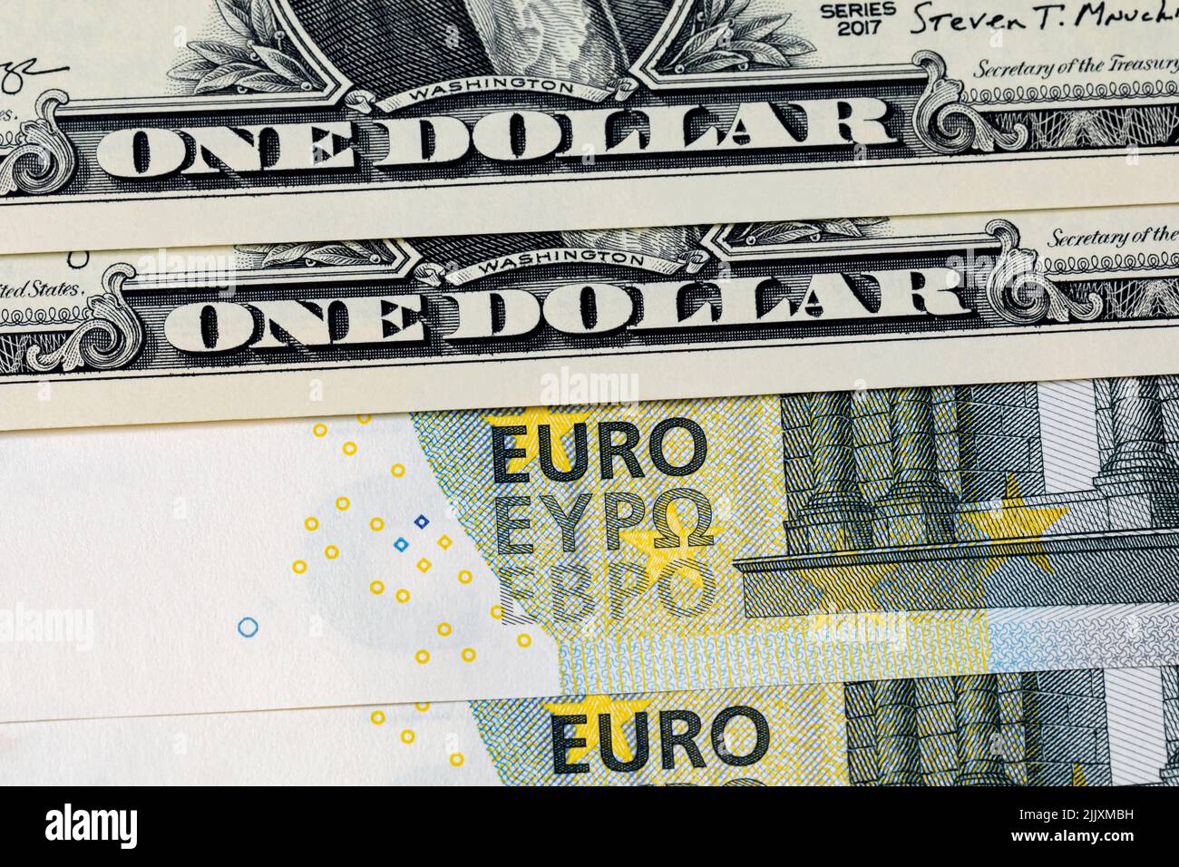 U.S. dollar bills and Euro banknote. Currency exchange rate, value and economy concept. Stock Photo