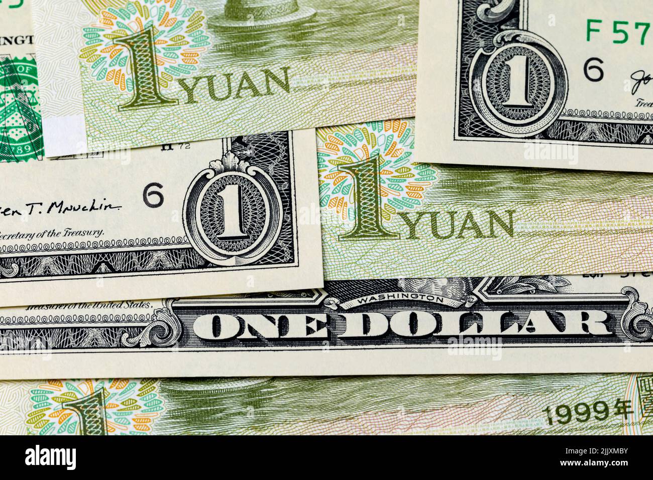 U.S. dollar bills and China Yuan banknote. Currency exchange rate, trade and economy concept. Stock Photo
