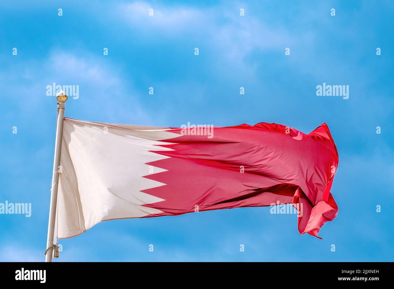 Qatar national flag waving in wind Stock Photo Alamy