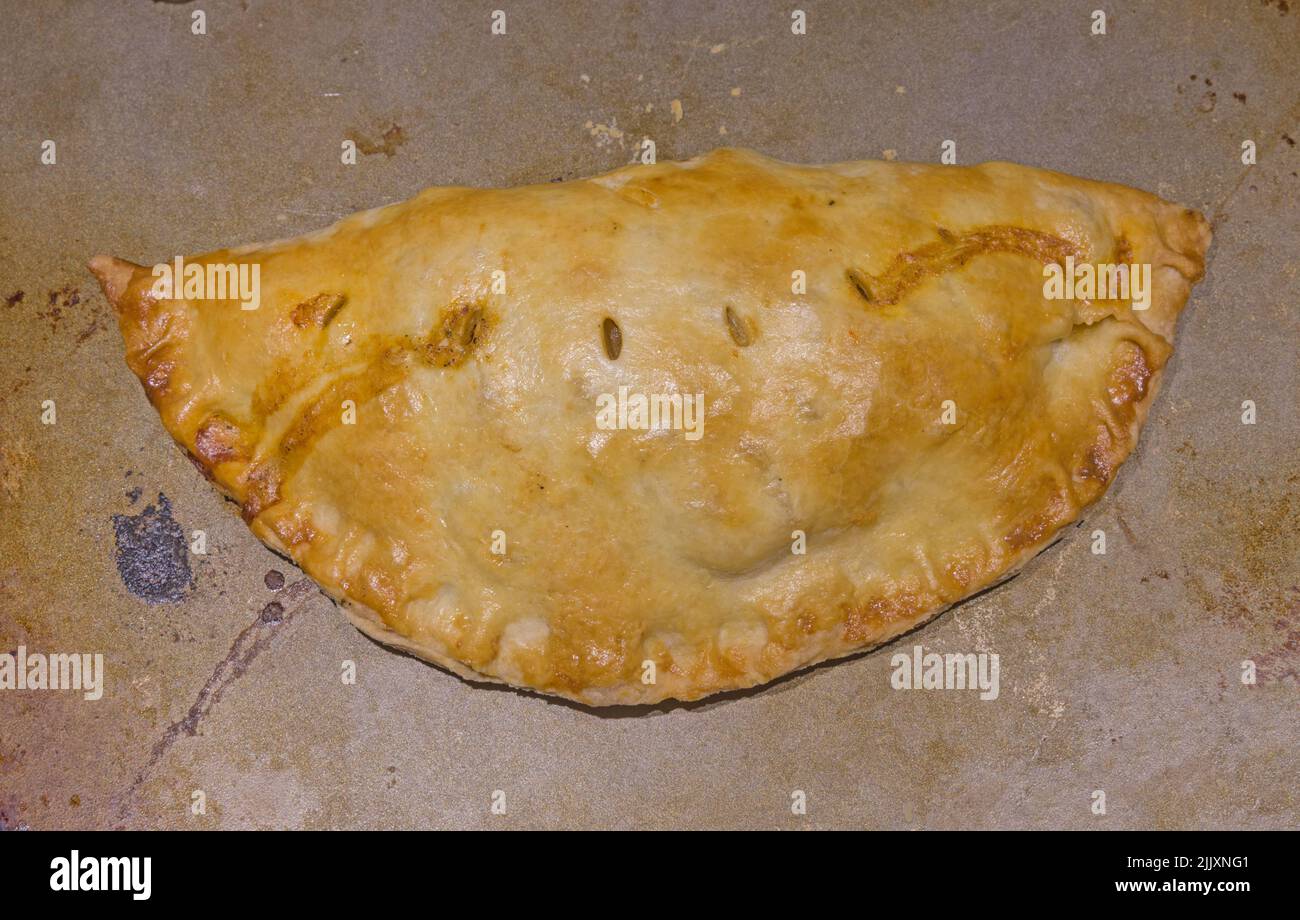 homemade Cornish pasty on a cooking sheet Stock Photo