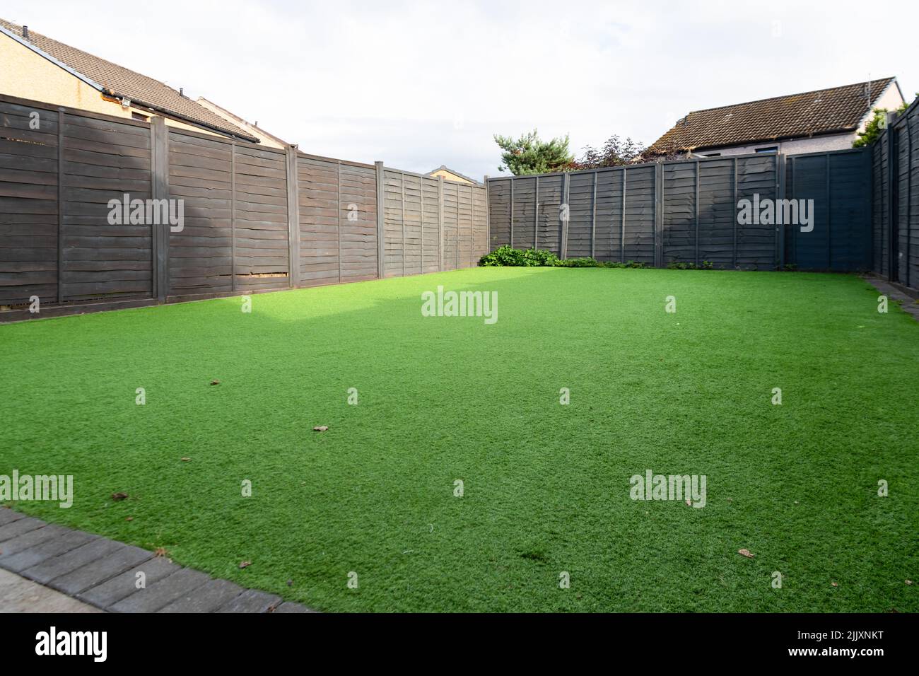 artificial turf lawn covered back garden - uk Stock Photo