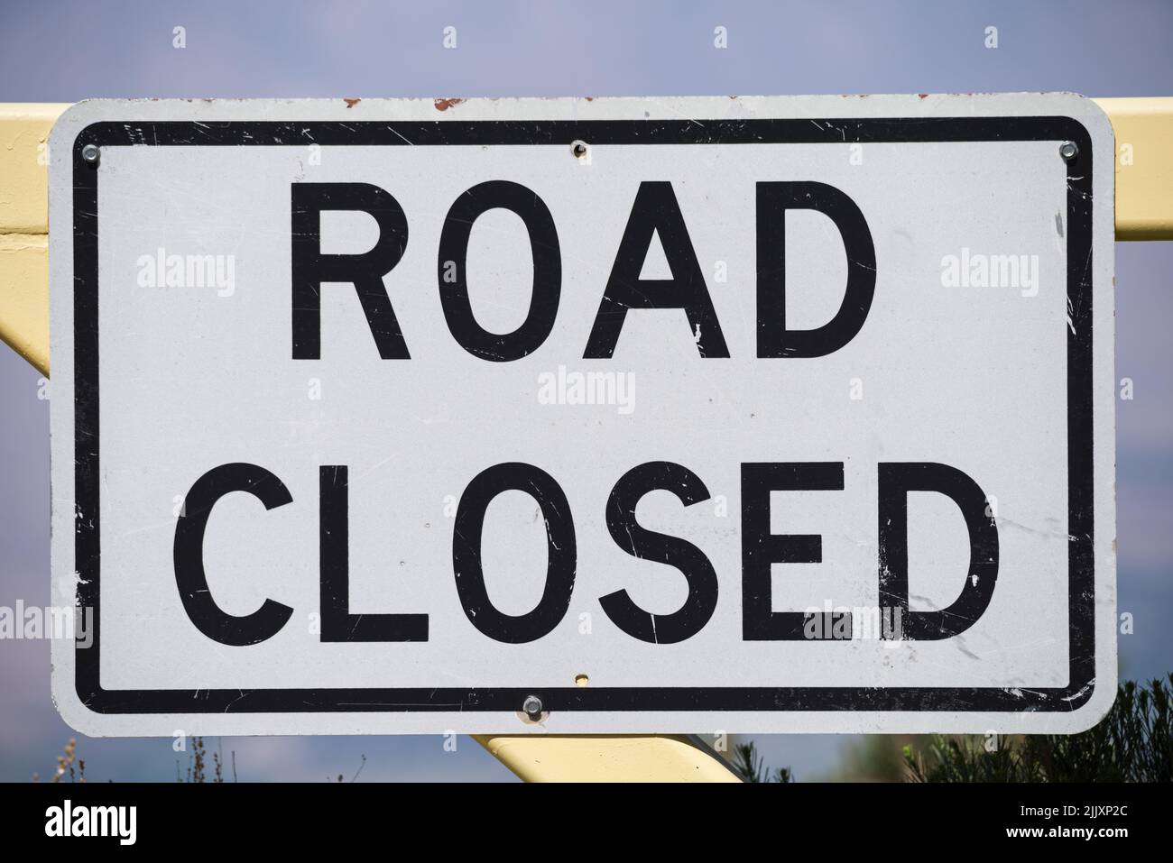white and black road closed sign on a metal gate Stock Photo