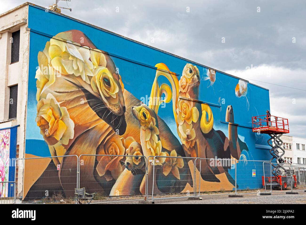 Weston-super-Mare, UK, 27 July 2022: Artist Curtis Hylton at work on the fifth day of Weston Wallz 2022. Weston Wallz is an annual event organised by Upfest, Europe’s largest street art festival, in partnership with Culture Weston and Weston-super-Mare Town Council. Stock Photo