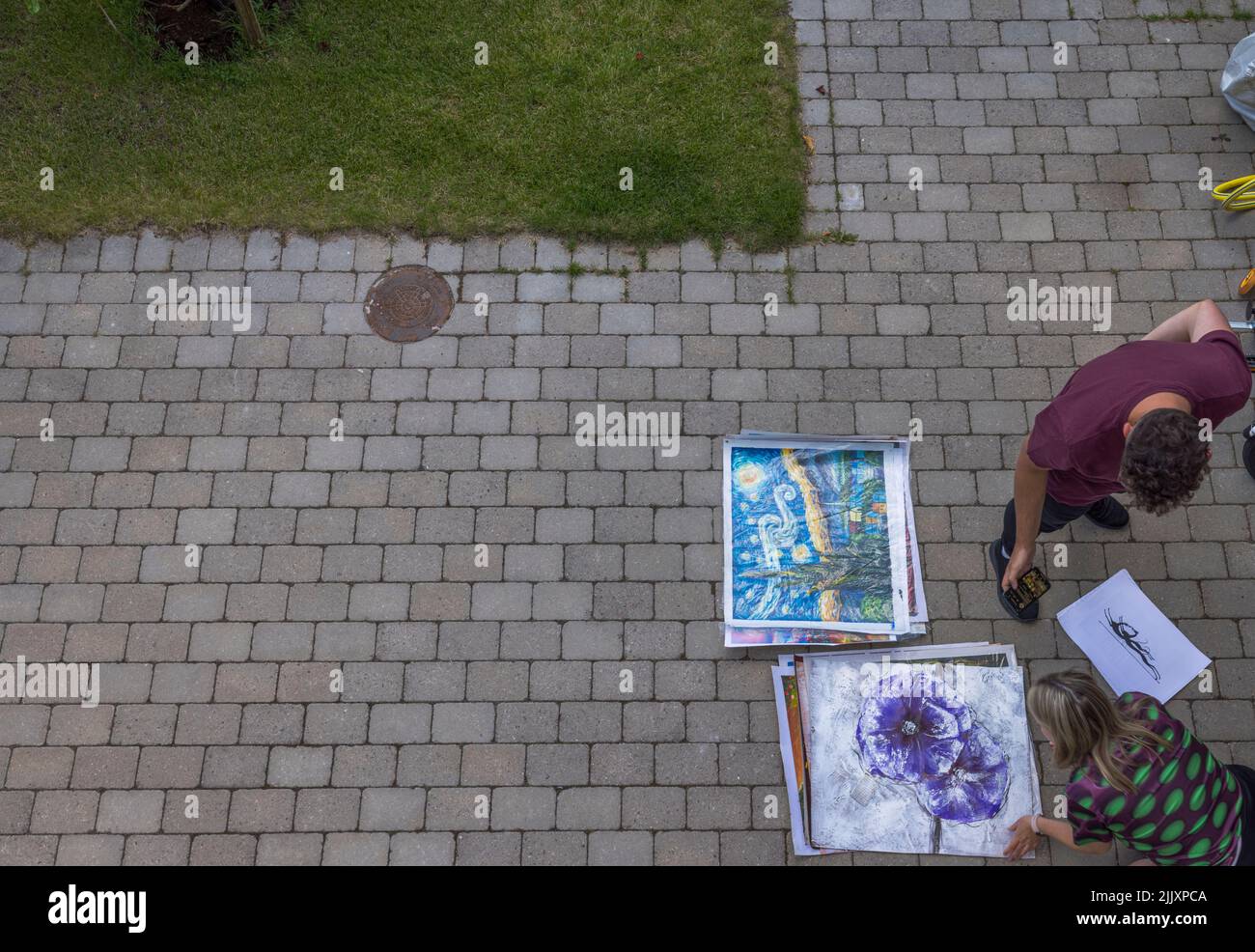 View of freelance painter selling his paintings to woman. Sweden Stock Photo Alamy