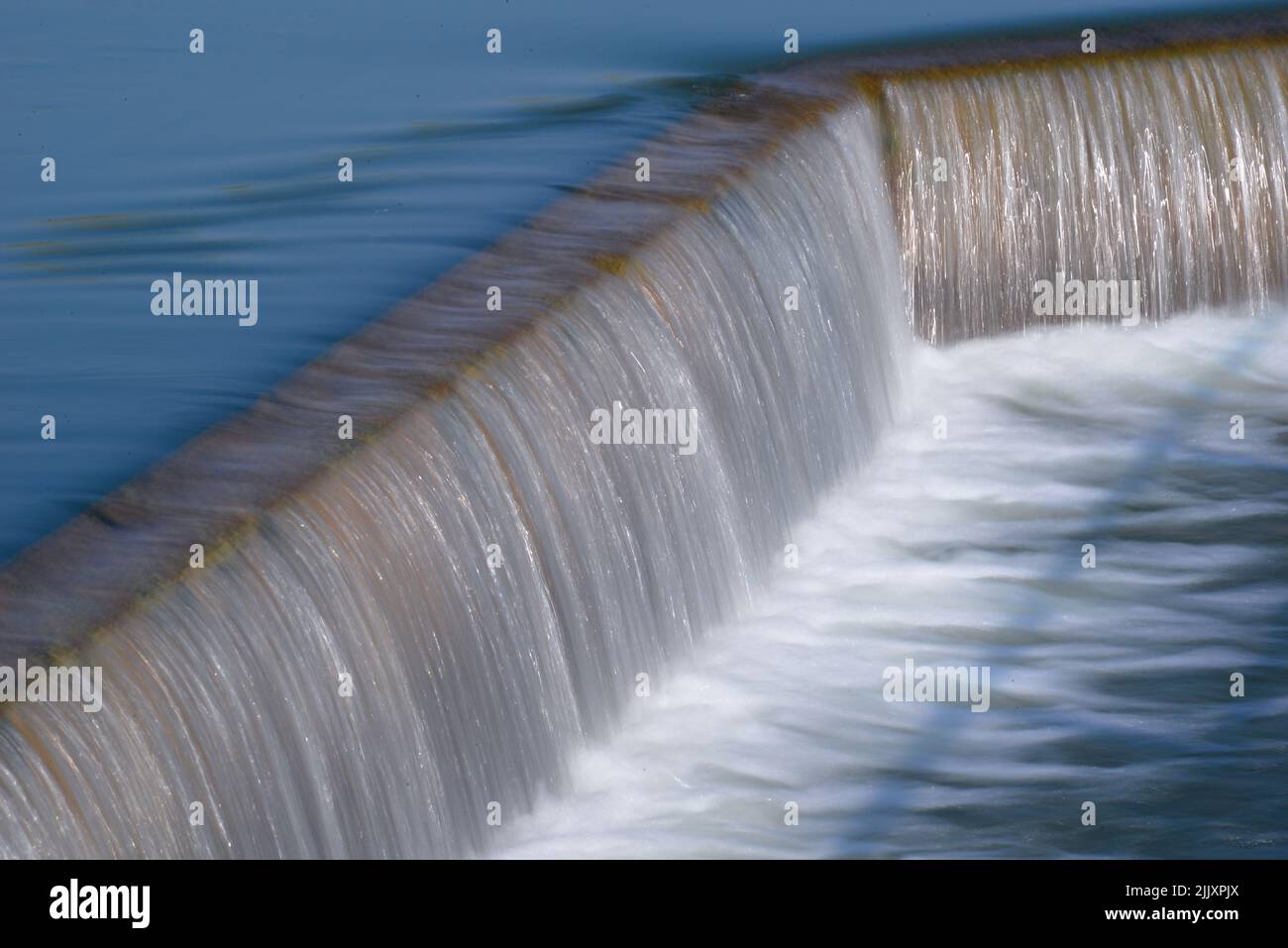 Water flowing over a waterfall of irrigation reservoir Stock Photo