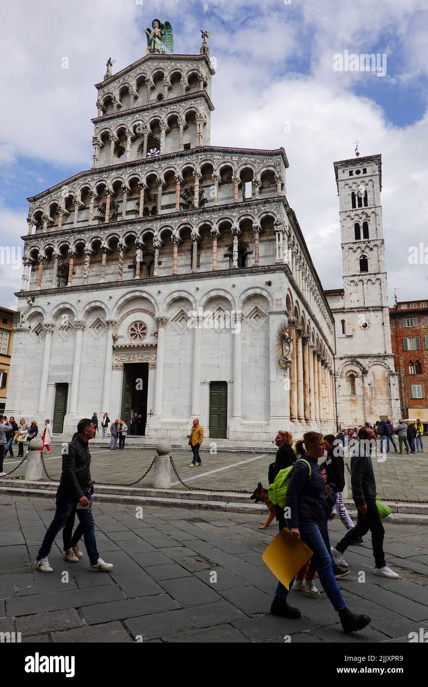 Chiesa di San Michele in Foro, basilica in Piazza di San Michele with people passing by, center of Lucca, Tuscany, Italy. Stock Photo