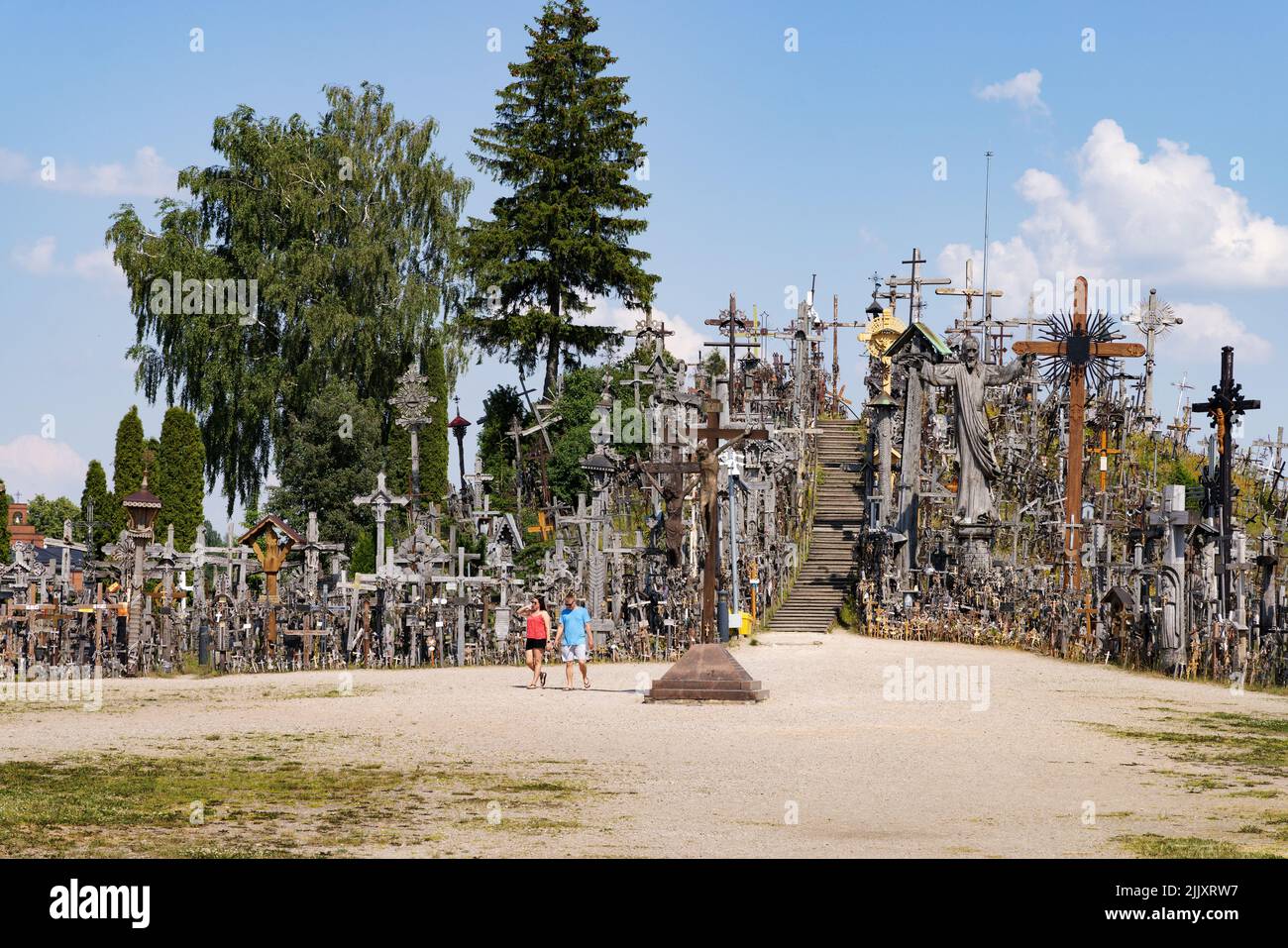 Lithuania travel; Visitors at the Hill of Crosses, Lithuania, a site of religious pilgrimage and tourist attraction, Siauliai, Lithuania, Europe Stock Photo