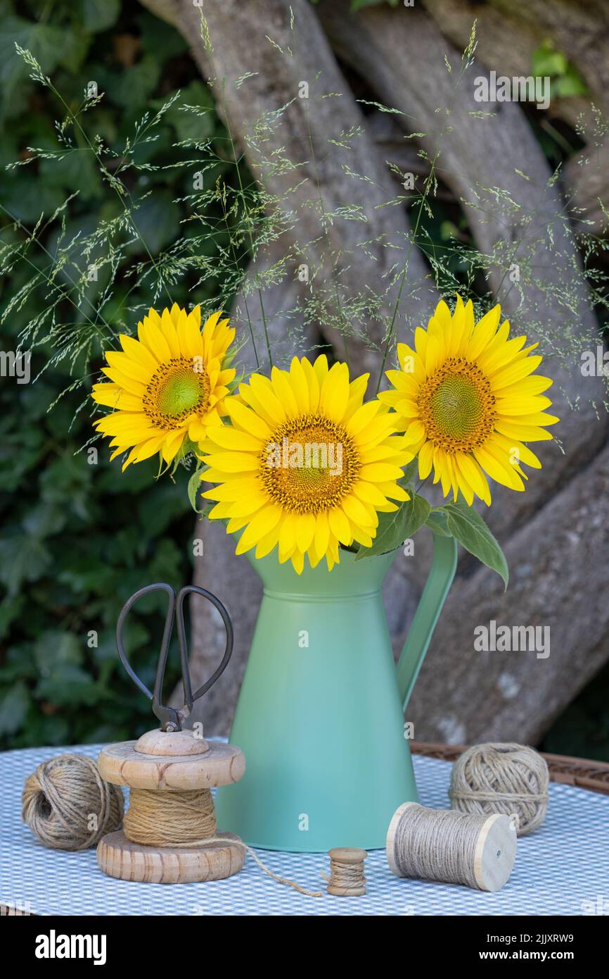bouquet of sunflowers and grasses in vintage jug Stock Photo