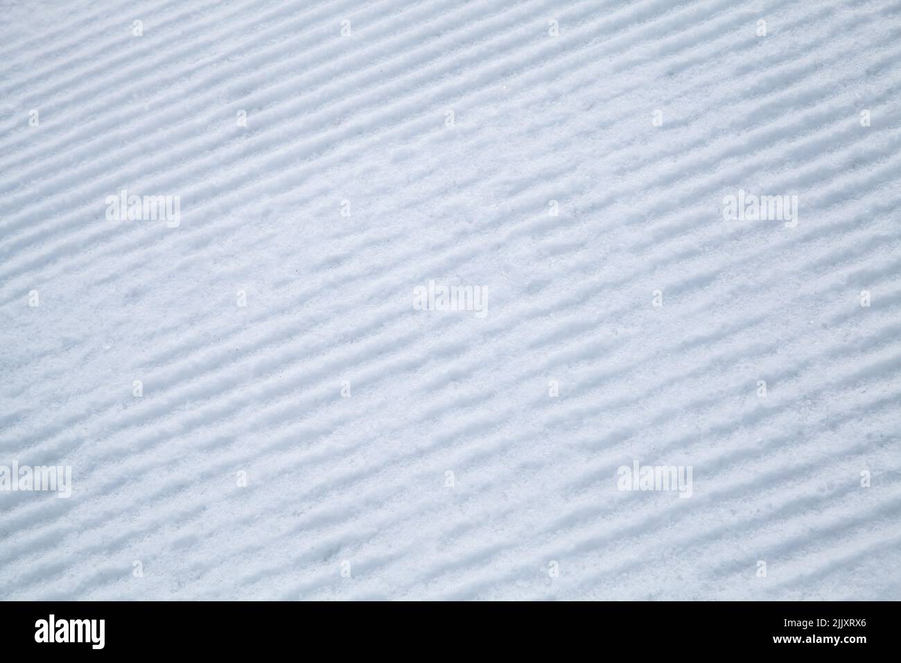 Striped texture of a snow on the ski slope Stock Photo