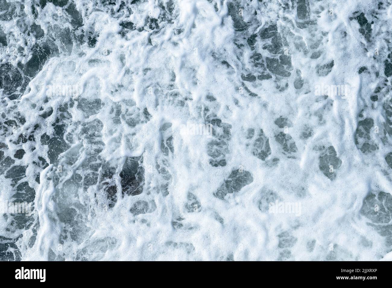 Sea water texture with splashes and foam, top view, natural background ...