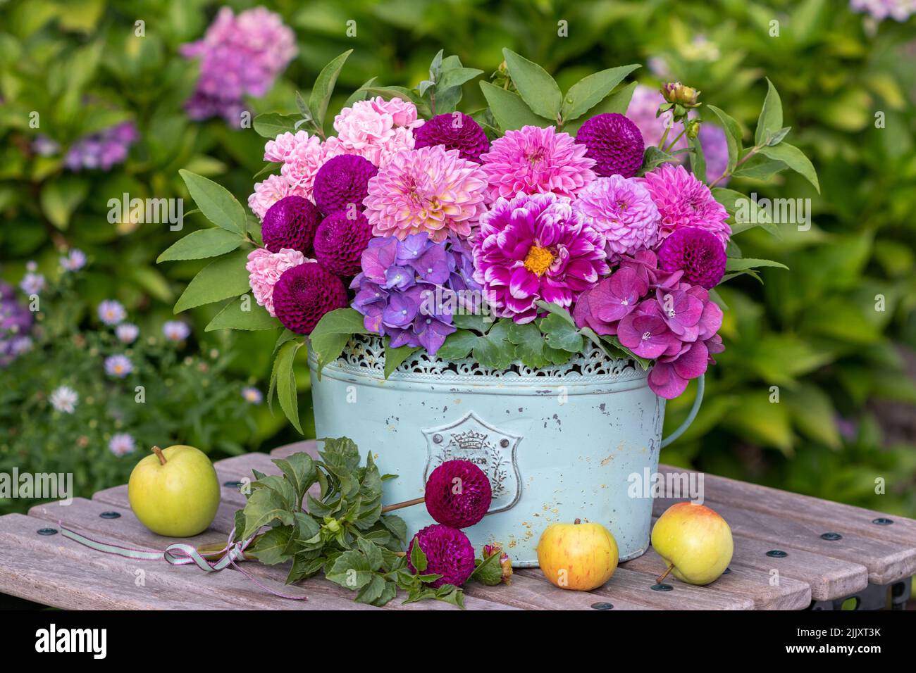 bouquet of pink dahlias, hydrangea flowers and roses in vintage pot Stock Photo