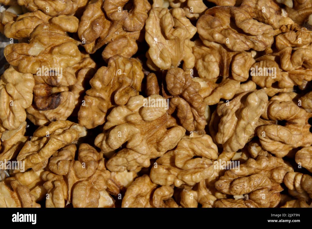 Background of many nuts from crushed walnut kernels, Sofia, Bulgaria Stock Photo
