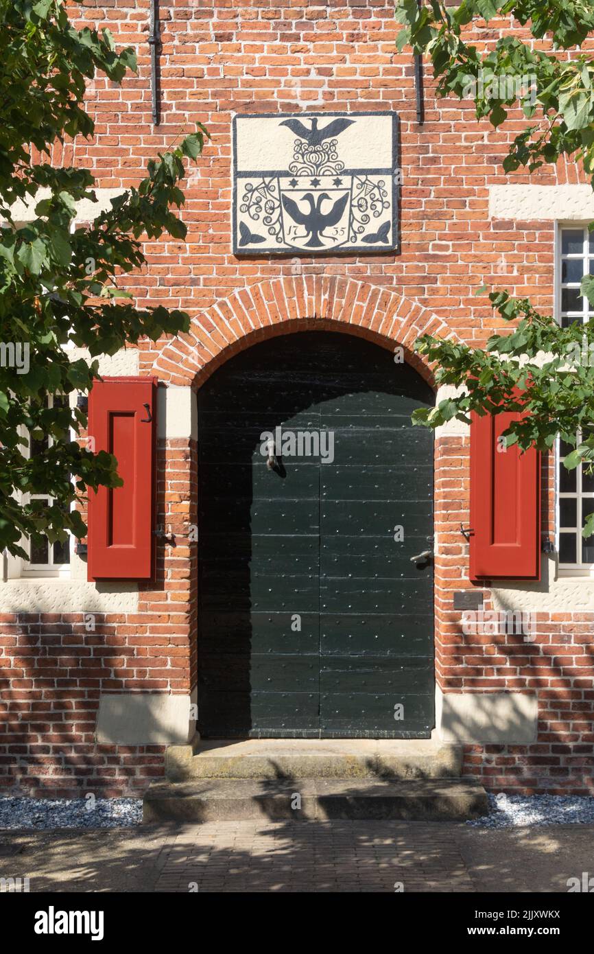 Entrance of the chieftain castle Steinhaus Bunderhee in Bunde, East Frisia, Lower Saxony, Germany. Stock Photo