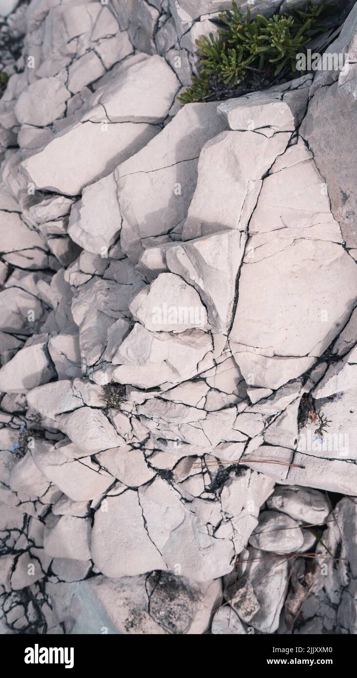 A vertical shot of white rock texture with cracks during daytime Stock ...