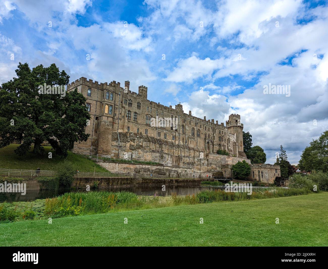 Warwick Castle s a medieval castle original built by William the Conqueror in 1068. View on the Medieval castle along the River Avon, Warwick, Warwick Stock Photo