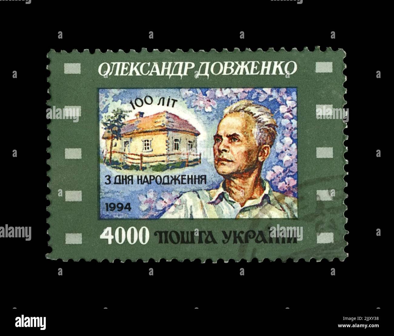 Alexander Dovzhenko, circa 1994. stamp printed in Ukraine shows famous ukrainian film producer vintage post stamp isolated on black background. Stock Photo