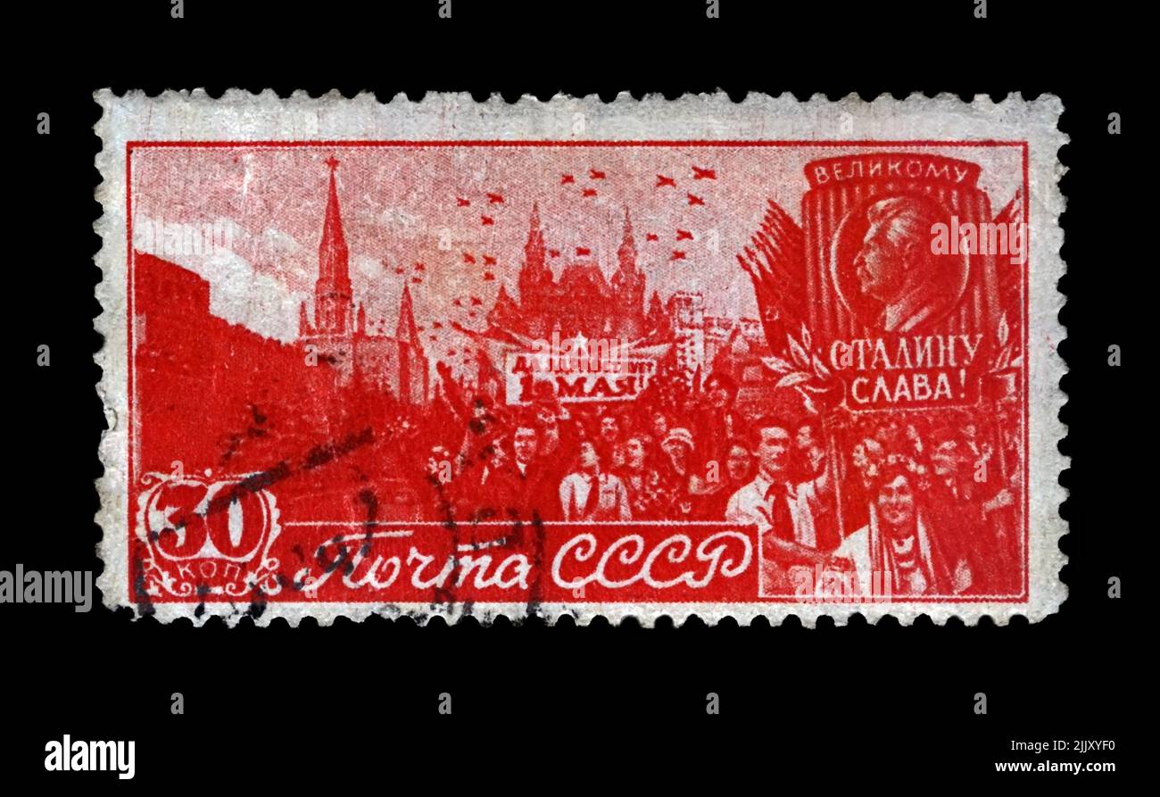 May Day Parade on Red Square in Moscow, circa 1947. canceled vintage post stamp rinted in USSR isolated on black background. Stock Photo