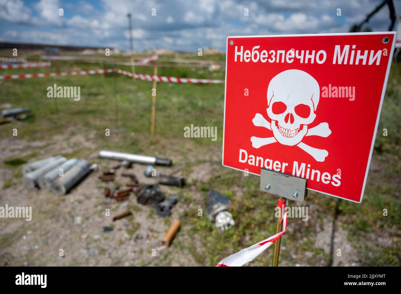 Hostomel, Ukraine. 25th July, 2022. On the grounds of Antonov Airport is a training area for the removal of mines and explosive ordnance. On the edge there is a warning sign with the inscription 'Danger Mines'. Credit: Christophe Gateau/dpa/Alamy Live News Stock Photo