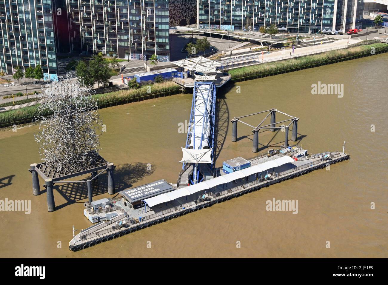 London, United Kingdom - June 2022: Aerial view of the jetty of the ferry terminal on the River Thames at the O2 Arena in Greenwich Stock Photo