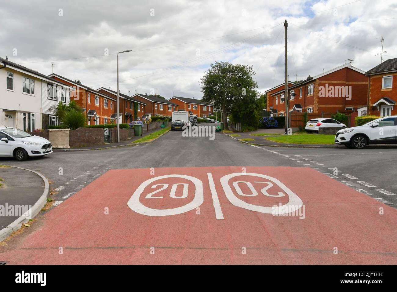 Llantrisant, Wales - July 2022: Road markings showing 20 mph speed limited painted on the street at the entrance to a housing estate. Stock Photo