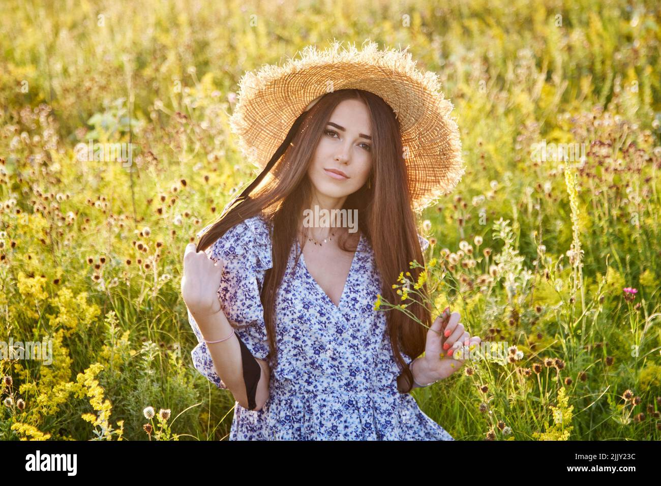 beautiful young girl with a straw hat in nature Stock Photo - Alamy