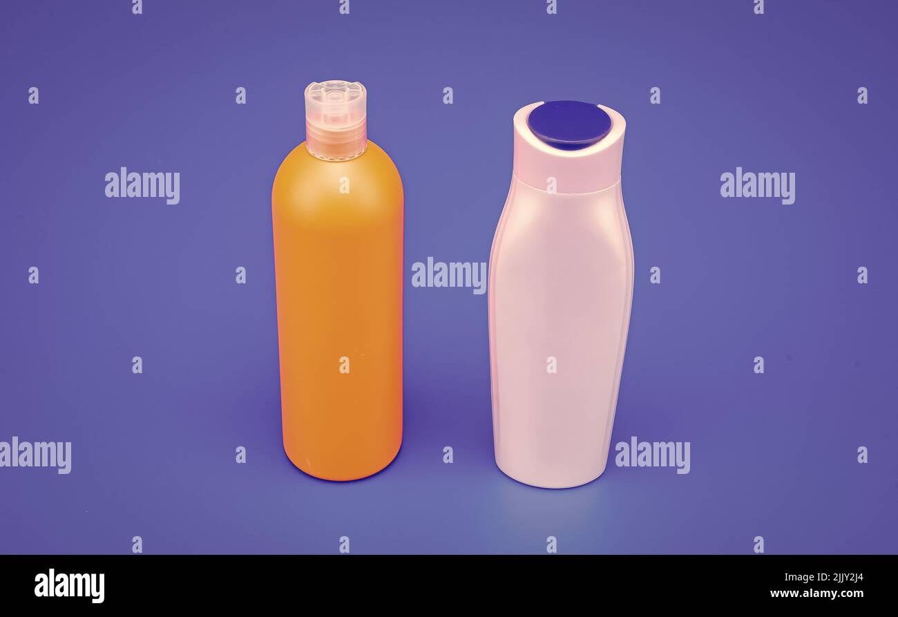 HDPE blue background. Refillable shampoo and conditioner bottles. Plastic cosmetic packaging