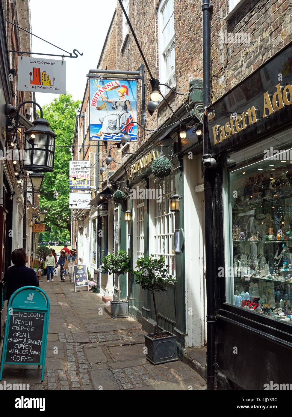 A view along looking down the shops in the narrow passageway of Brewers Lane Richmond in London Stock Photo