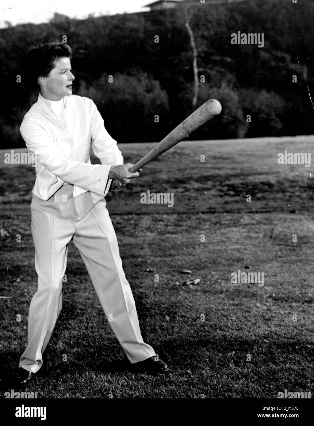 All American Girl ... Katharine Hepburn is the all-round athlete in MG-M's 'Pat and Mike' romantic comedy in which she co-stars with Spencer Tracy. He's the sports promoter and she the gal who's a whiz at tennis, golf, baseball, cycling, or what have you in the way of sports - a good sport. Directed by George Cukor. Produced by Lawrenced Weingarten. Written by Ruth Gordon and Garson Kanin. September 1, 1952. Stock Photo