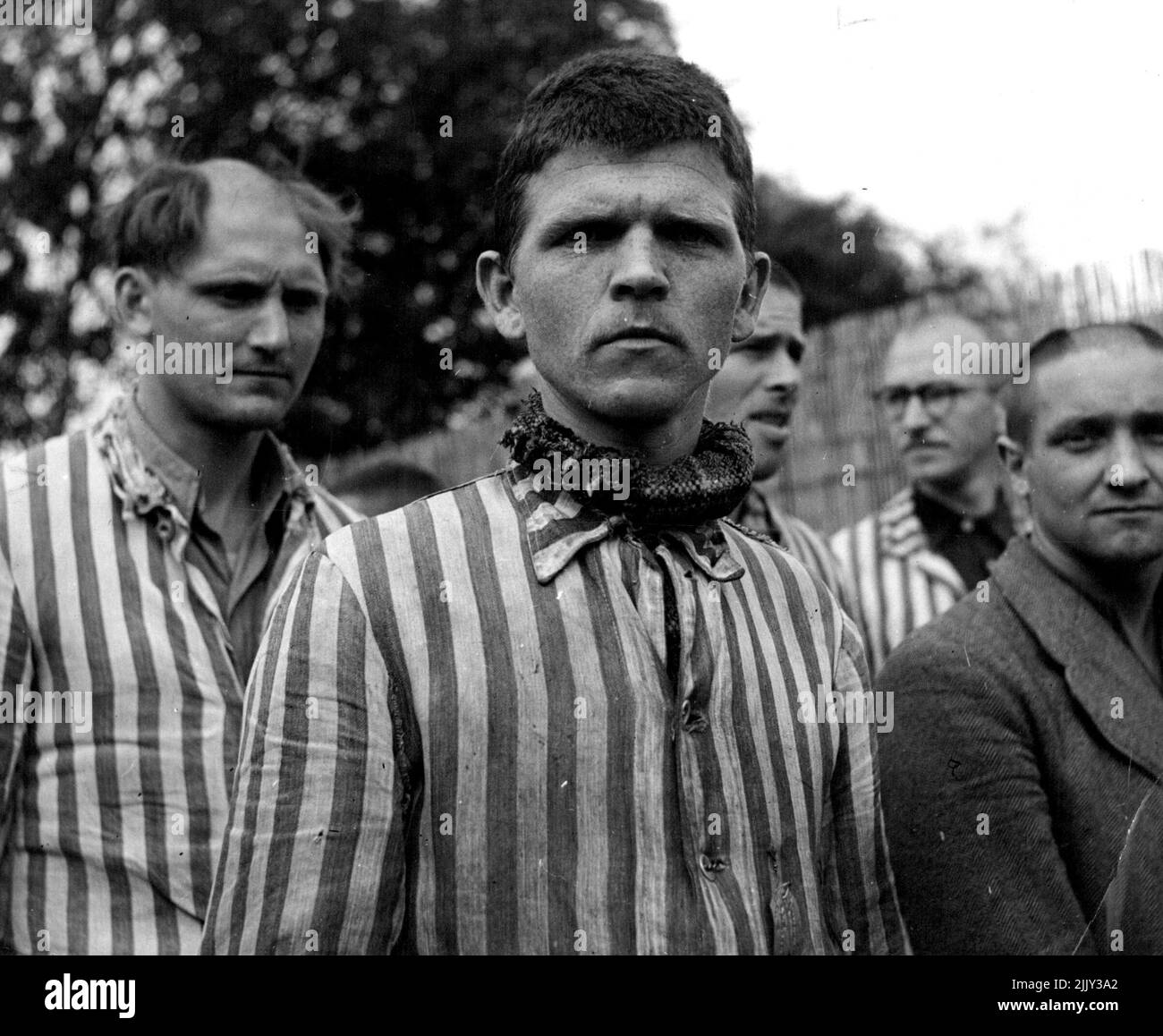 Faces of Dutch Waffen S.S. men. After the notorious concentration-camp Vught (in the Southern part of the Netherlands) had been liberated by the allied arrives, it has become a camp for Dutch collaborators are now in that camp. 300 Belong to the 'Netherlands Waffen S.S.' They are dressed in the same prisonsuits as formerly the underground resistant members were put-in after they had been transported to Vught. June 01, 1945. (Photo by Anefo). Stock Photo